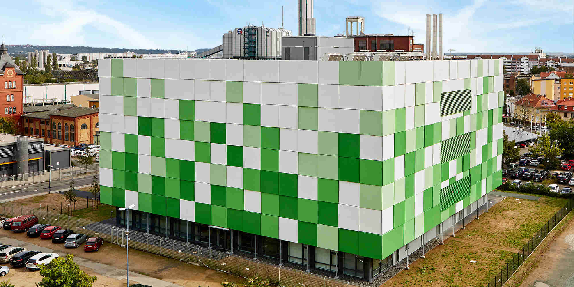 A green / white building located in a city